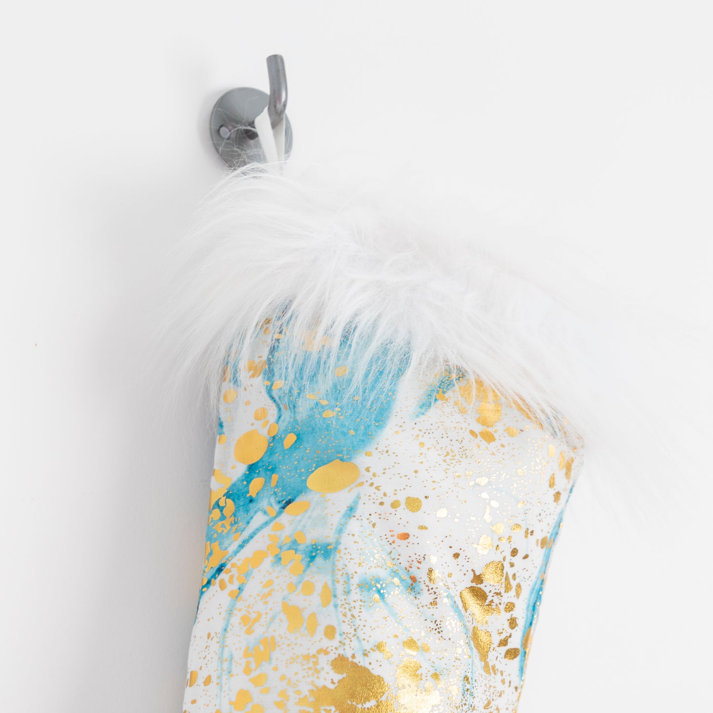 close up of blue & gold xmas stocking with faux fur trim