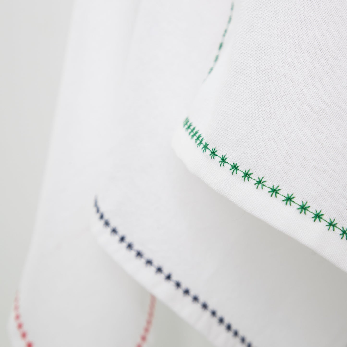 white cotton napkins with decorative trim