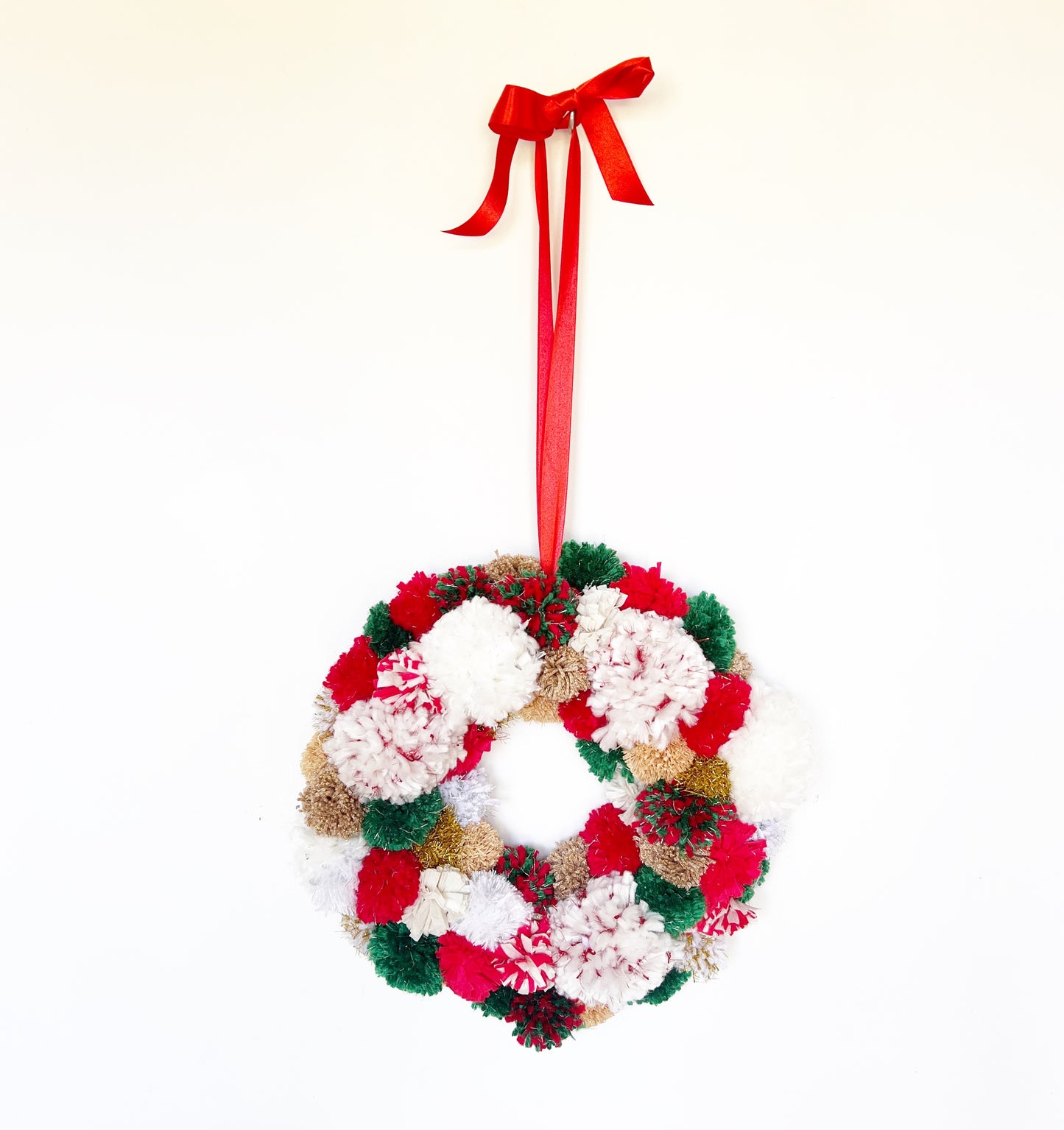 Red, Green, White Pom Pom Christmas Wreath. Handmade using a variety of yarns.