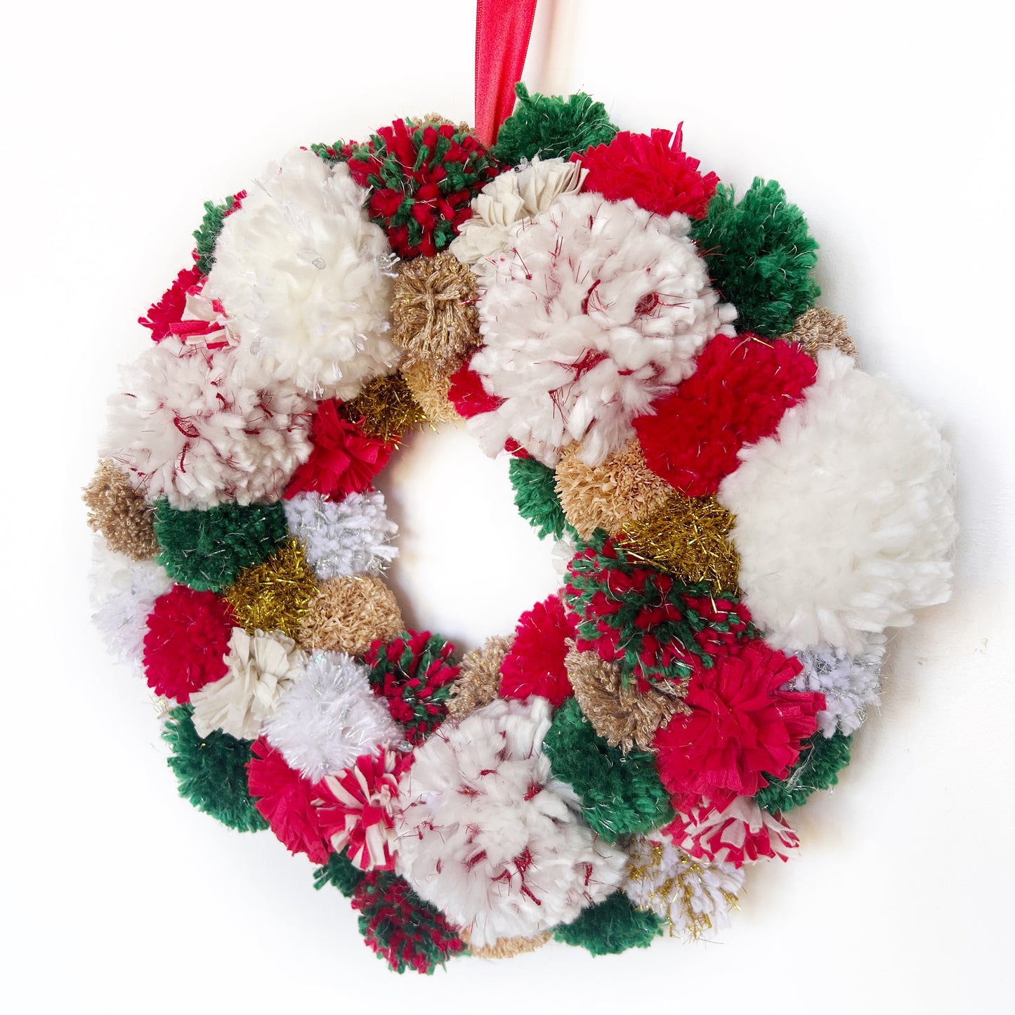 Red, Green, White Pom Pom Christmas Wreath. Handmade using a variety of yarns.