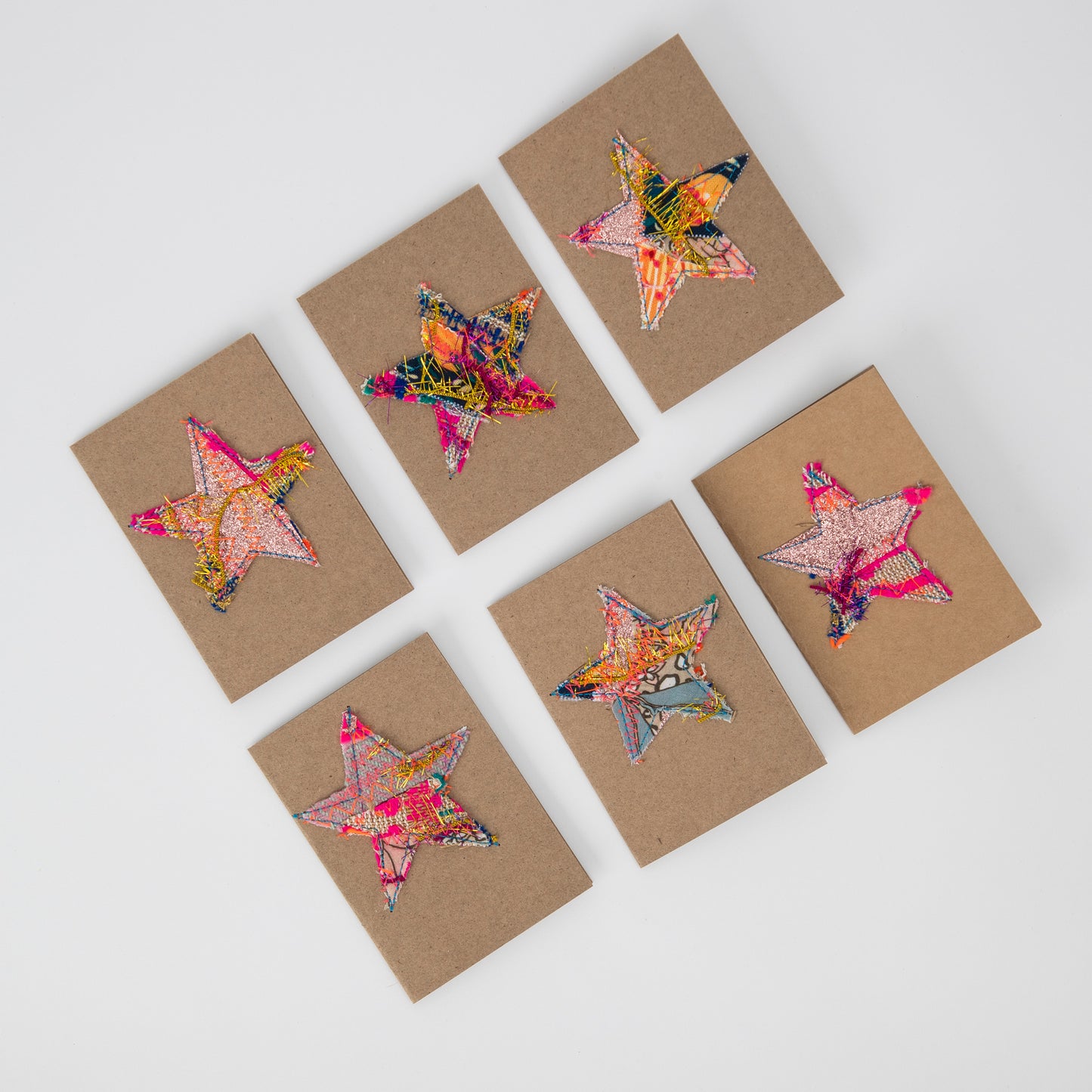 fabric stars sewn onto brown gift cards. no two the same!