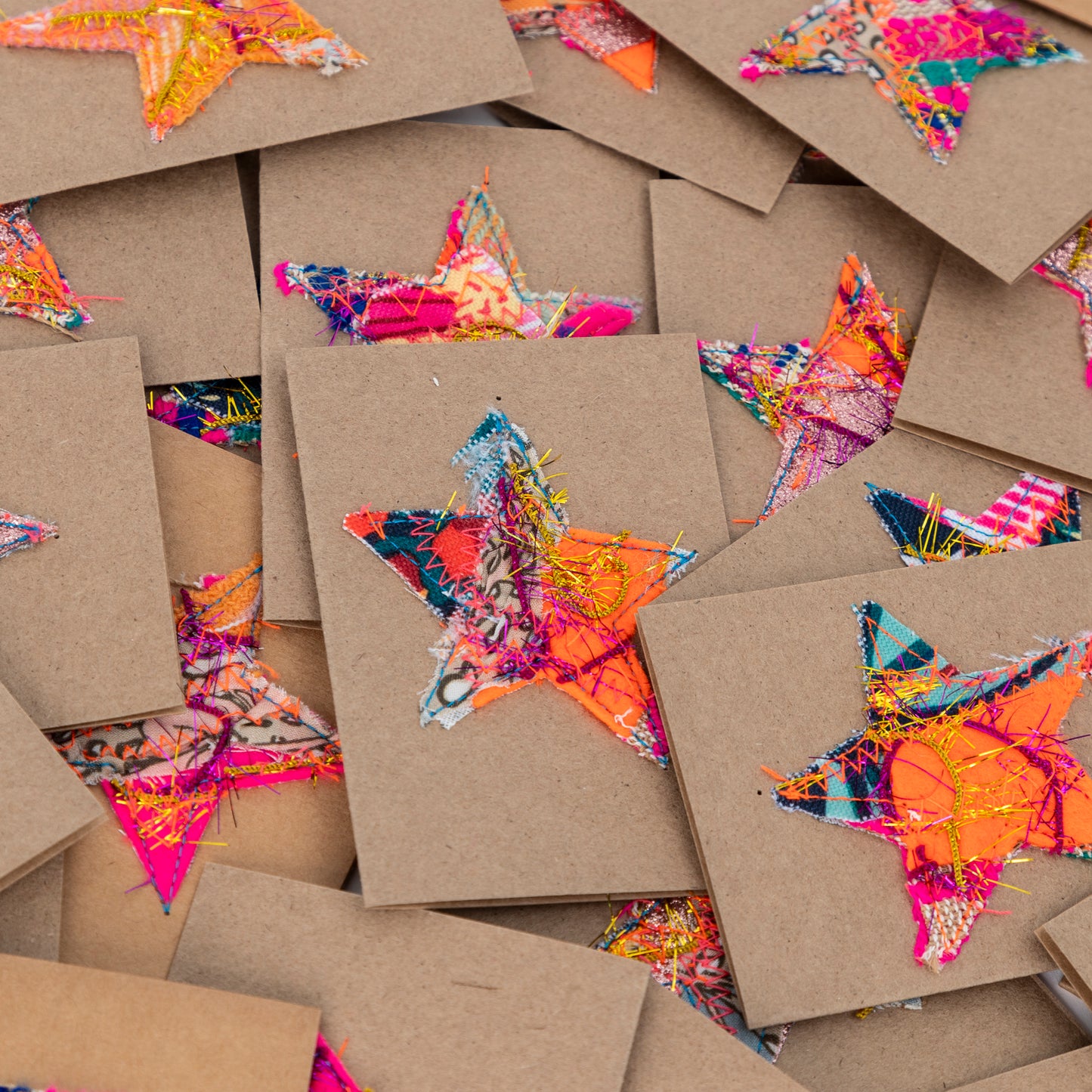 fabric stars sewn onto brown gift cards. no two the same!