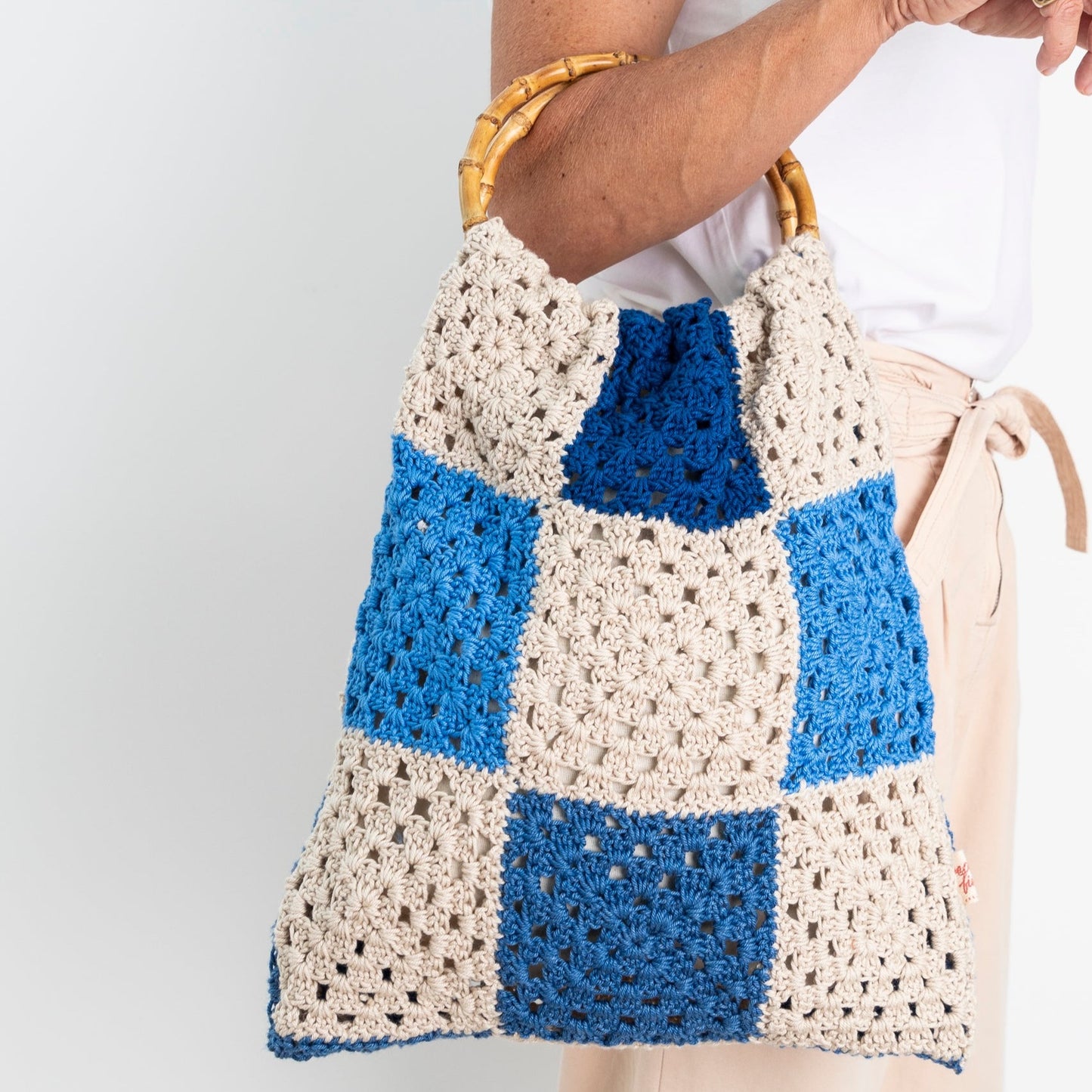 Repurposed, Crochet Blanket made into a bag with bamboo handles.