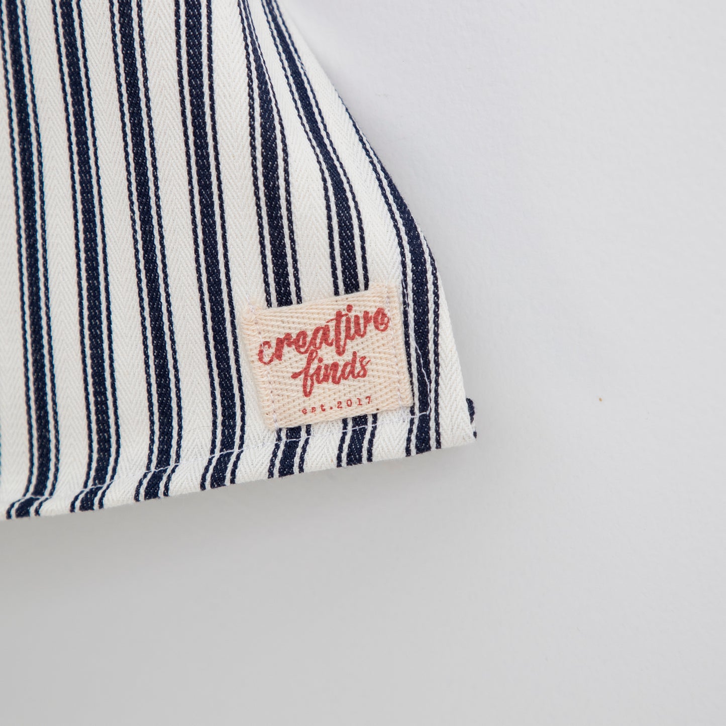 close up of fabric and label on front bottom corner