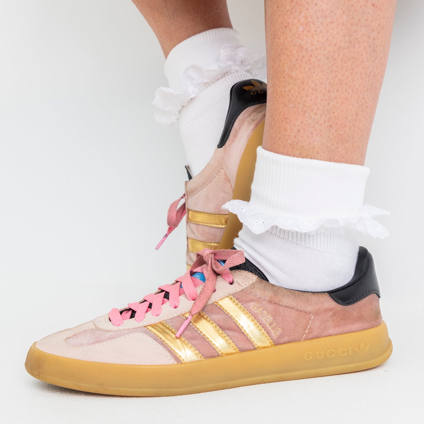 lace trim white ankle socks worn here, folded over with sneakers