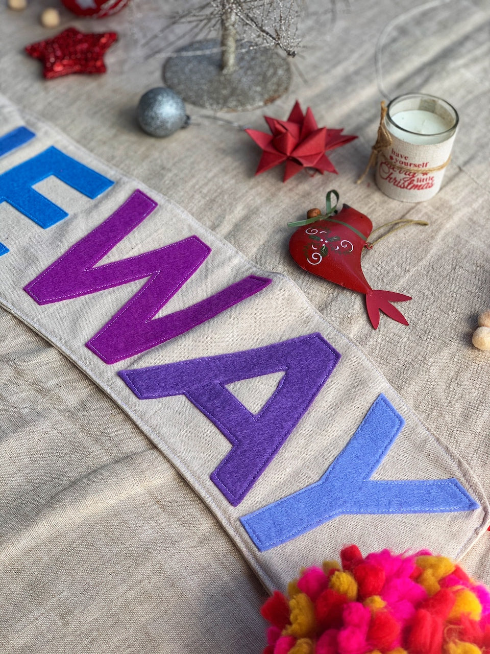 close up felt letters spelling WAY