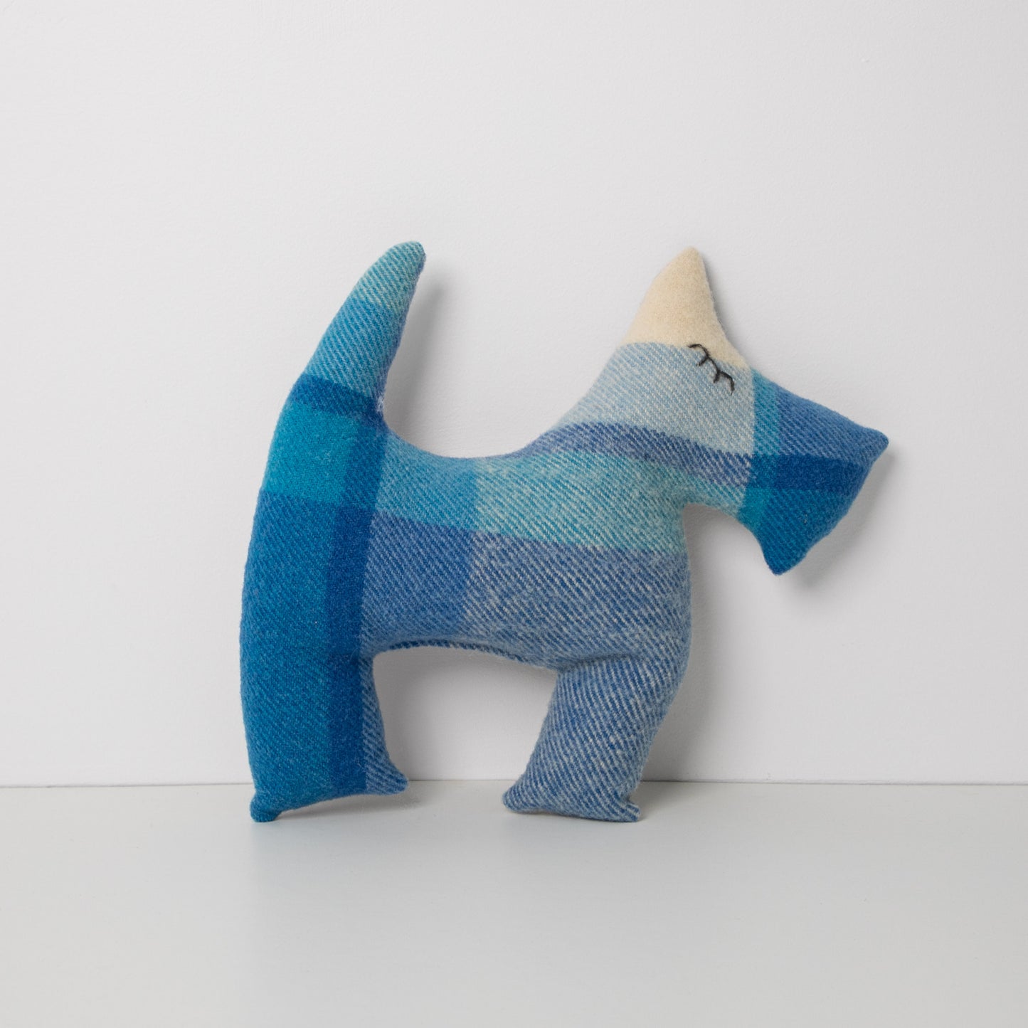 Blue Blanket up-cycled to make this Scotty Dog, standing on white background