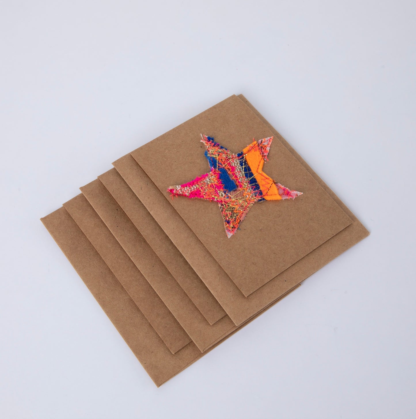 fabric stars sewn onto brown gift cards. no two the same!