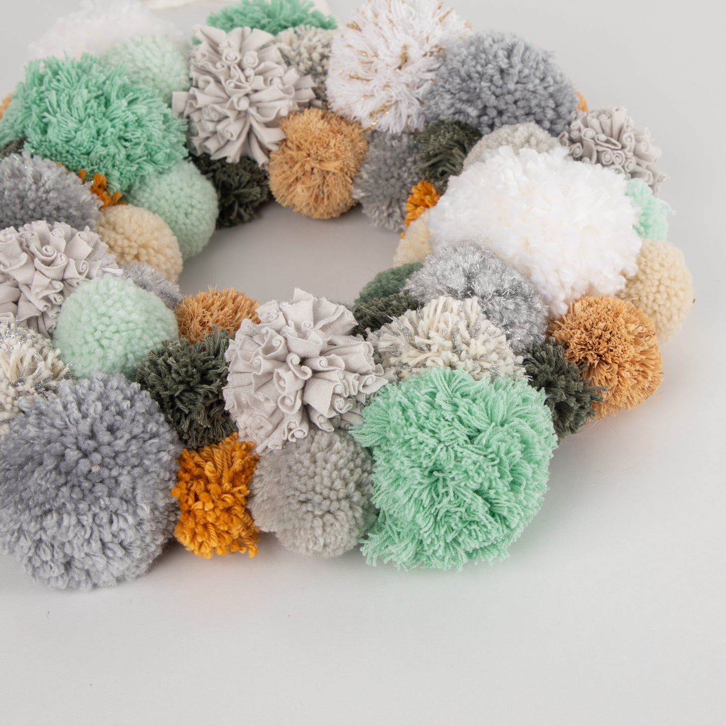 close up of green pompom wreath
