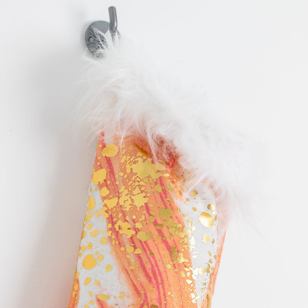 
                  
                    close up of orange & gold xmas stocking with faux fur trim
                  
                