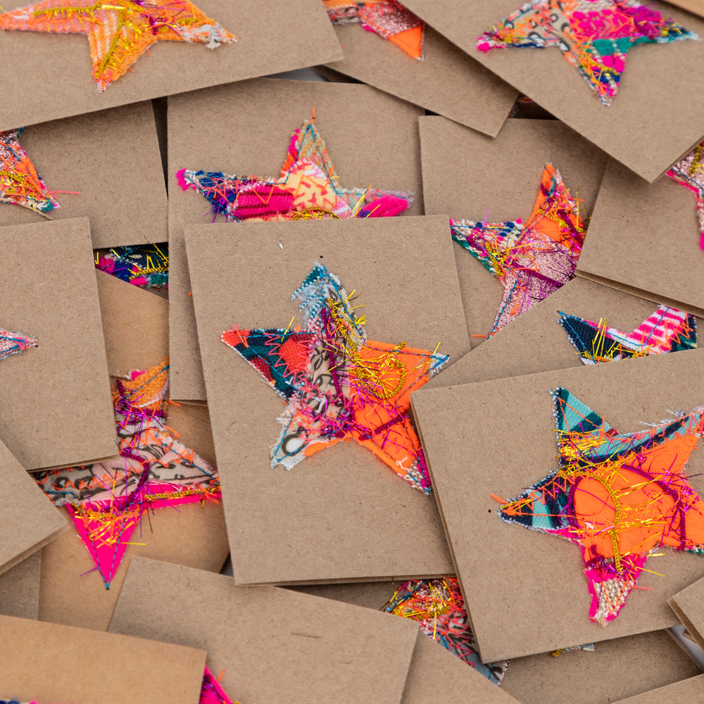 
                  
                    fabric stars sewn onto brown gift cards. no two the same!
                  
                