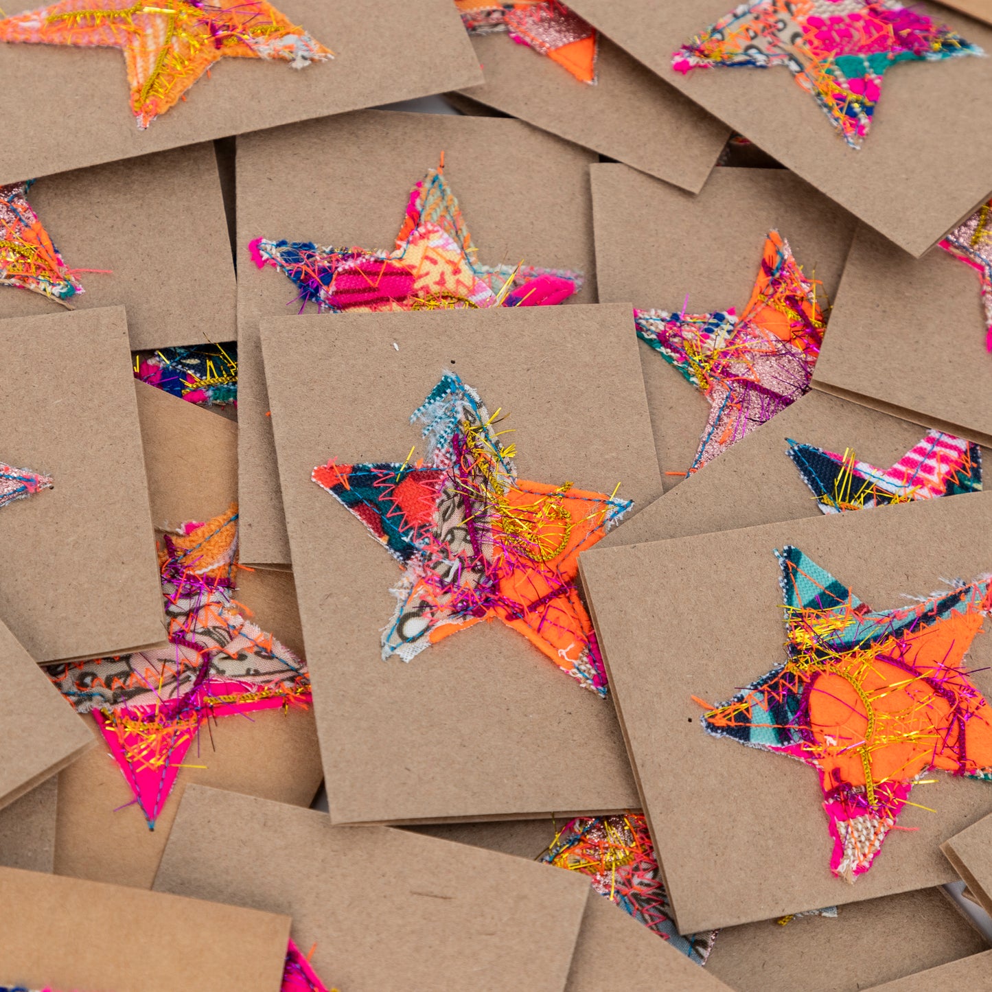
                  
                    fabric stars sewn onto brown gift cards. no two the same!
                  
                