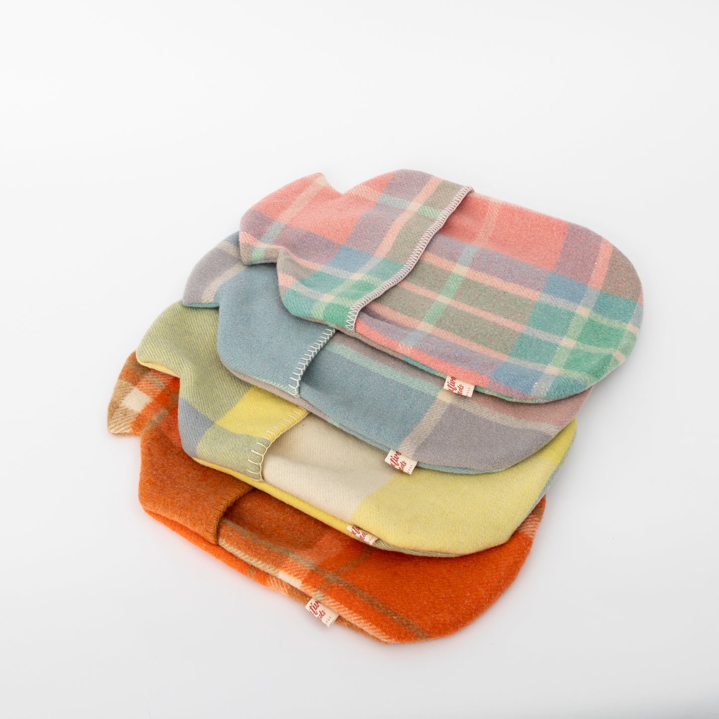 woollen hot water bottle covers - 4 new colour styles stacked on top of one another