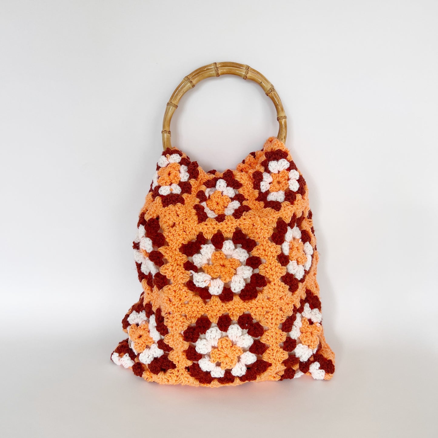 
                  
                    orange, brown & white crochet bag with bamboo handles
                  
                