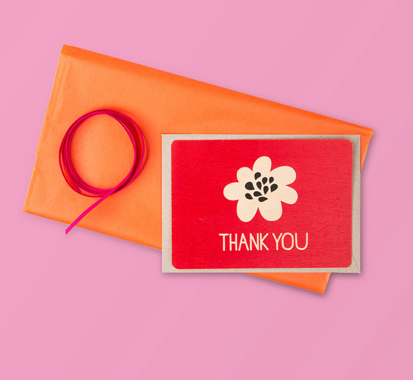 Timber Red Thank YOu Postcard on orange tissue paper, with red ribbon and pink background