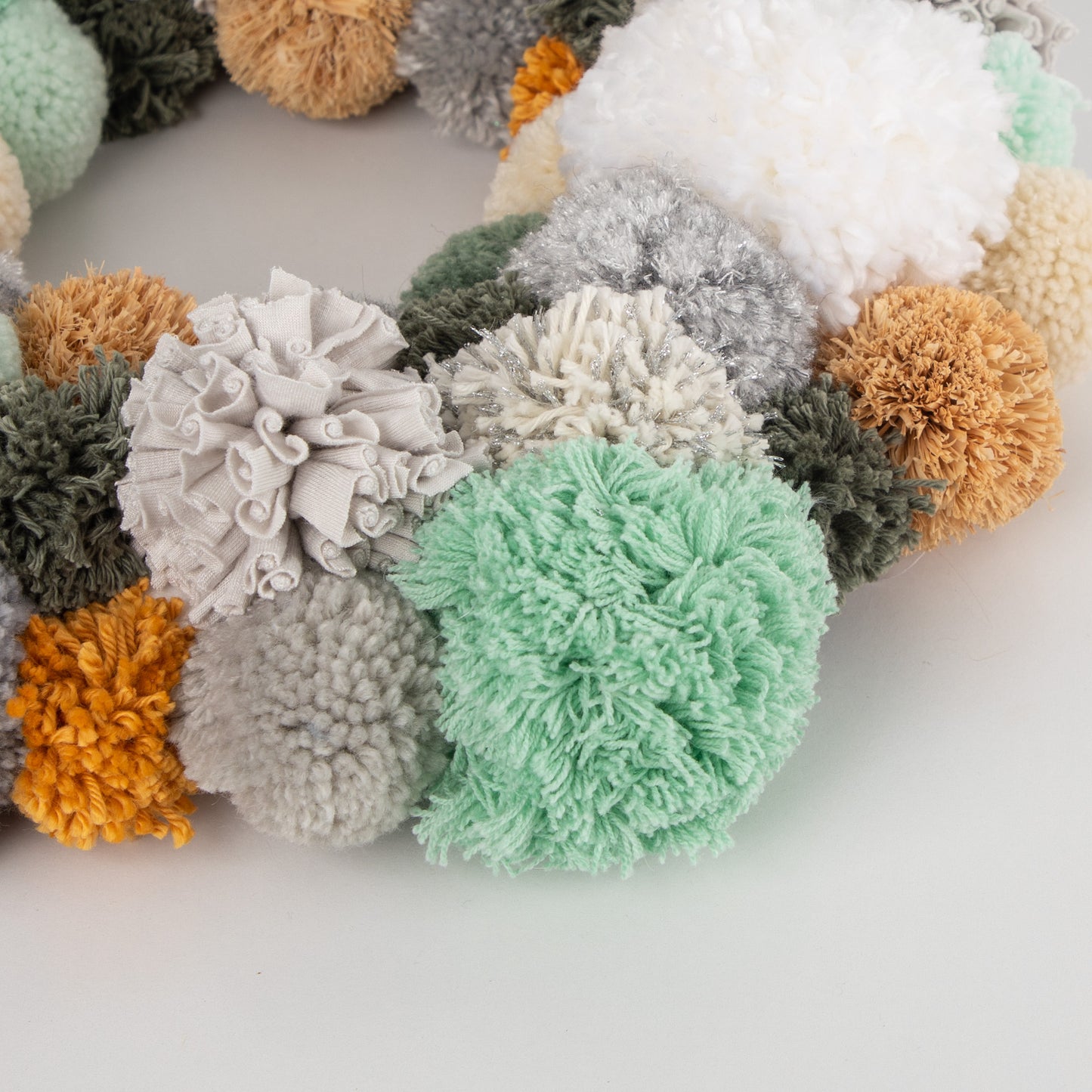 
                  
                    Earthy Cool - close up of various pompom sizes and textures
                  
                
