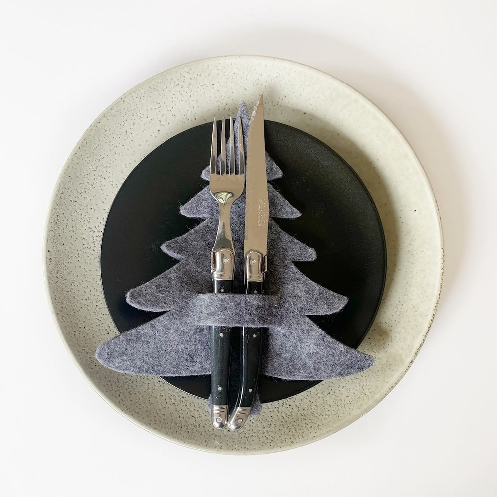 grey felt christmas tree cutlery holder on plate